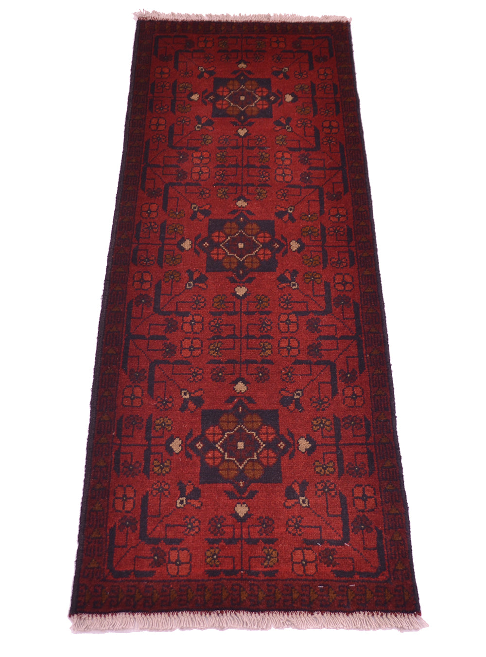 A traditional afghan runner rug with a deep red field, dark navy blue borders, and central medallions in beige, brown, and muted green, finished with light fringe on a white background.
