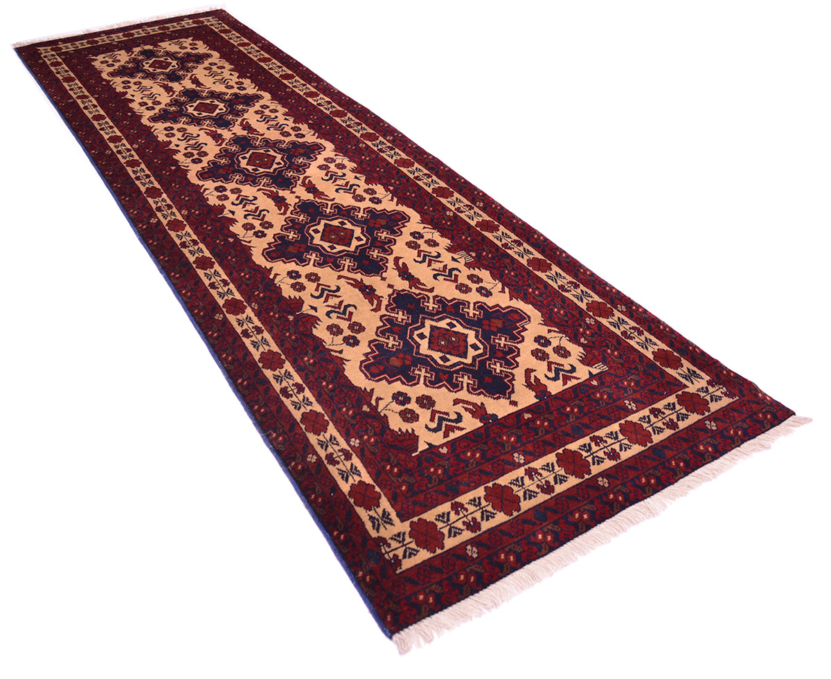 A long rectangular area runner with a traditional pattern, featuring a deep red and blue border, on a beige field, shown on a plain white background
