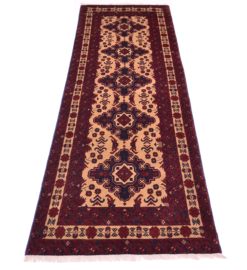 A traditional runner rug with a geometric pattern in deep red, beige, and navy blue, shown flat against a white background.