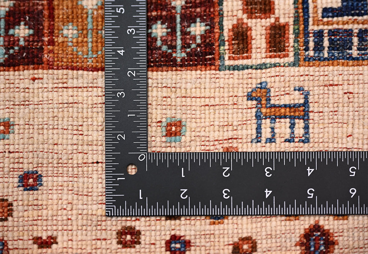 Hand-knotted Afghan Loribaft Gabbeh rug close-up with ruler showing the scale of the knotting and small geometric motifs.