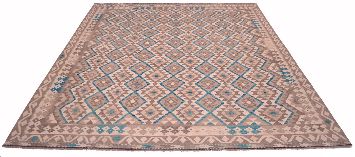 A large Afghan Kilim area rug with a geometric diamond pattern in beige, brown, and turquoise blue, shown from a top-down perspective against a white background.