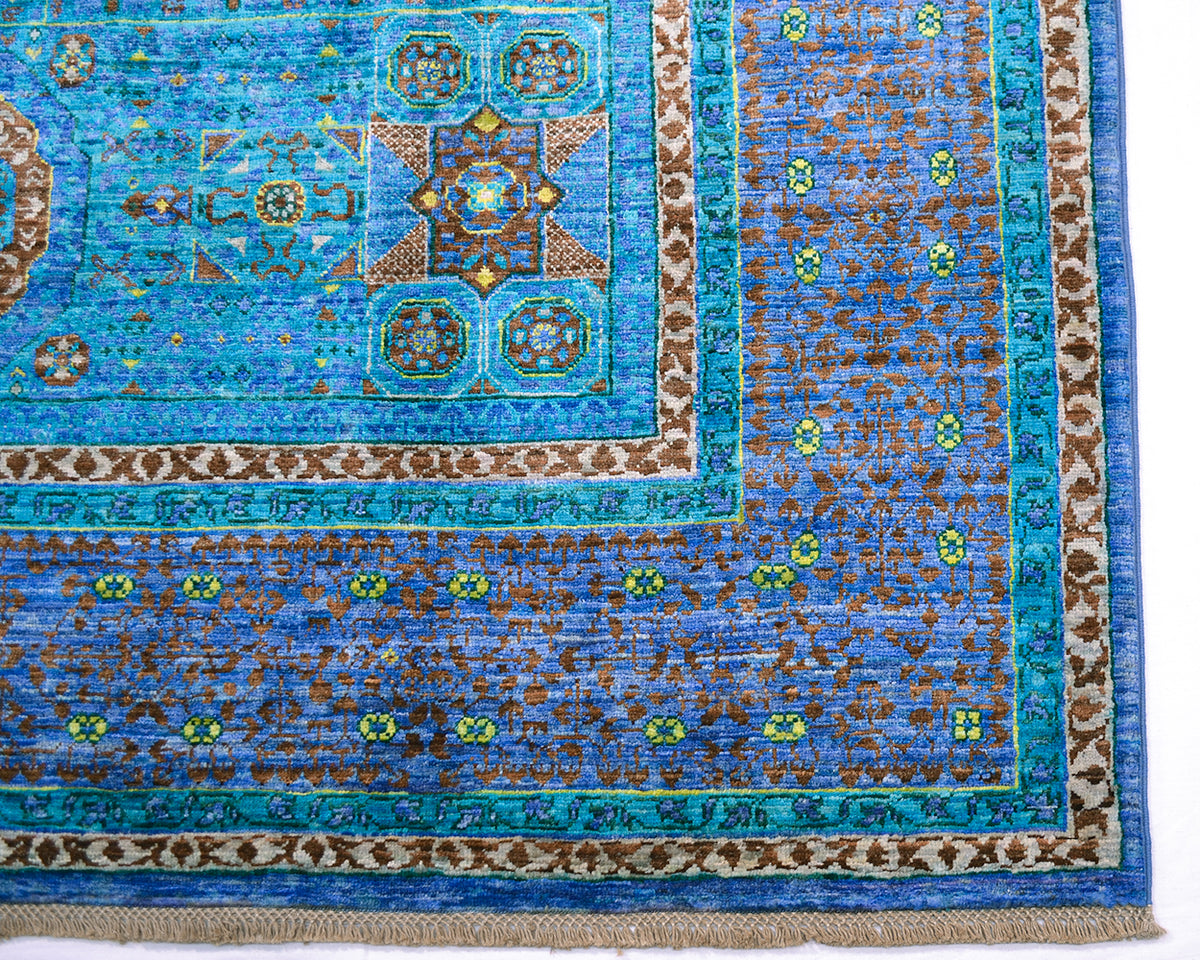 Corner detail of geometric carpet in blue and turquoise.