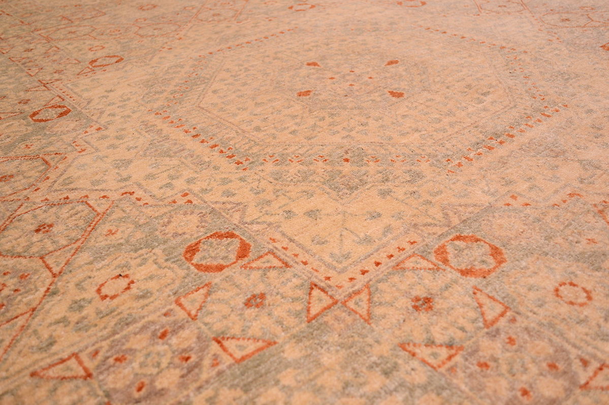 Medallion close up of pale Mamluk carpet with sage green blues and rust tones