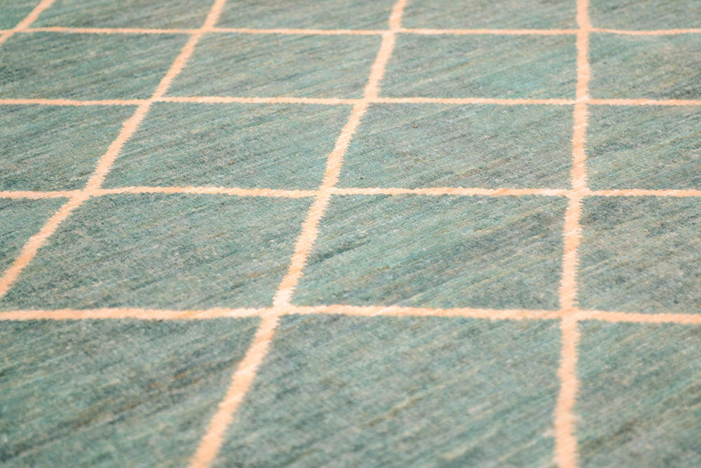 View and close up detail of Afghan Carpet in light turquoise and golden light cream/ beige simple lattice. pattern.