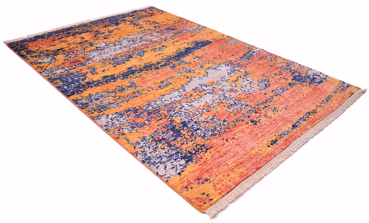 Abgles view of abstract modern carpet hadnknptted in Afghanistan with coral terracotta, amber gold, soft grey blue and deep blue abstract fragmented erosion design.