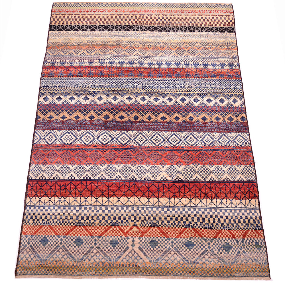 Geometric carpet with pure wool pile woven on wool warps. Multiple bands of pattern across the width of the carpets with variety of diamonds and geometric motifs and small chequerbaords squares.