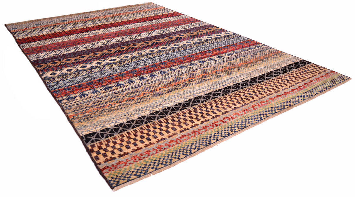 Angled view of geometric carpet with reds, blues, black, aubergine, greens and amber. Multicoloured carpet with bands of patterning.