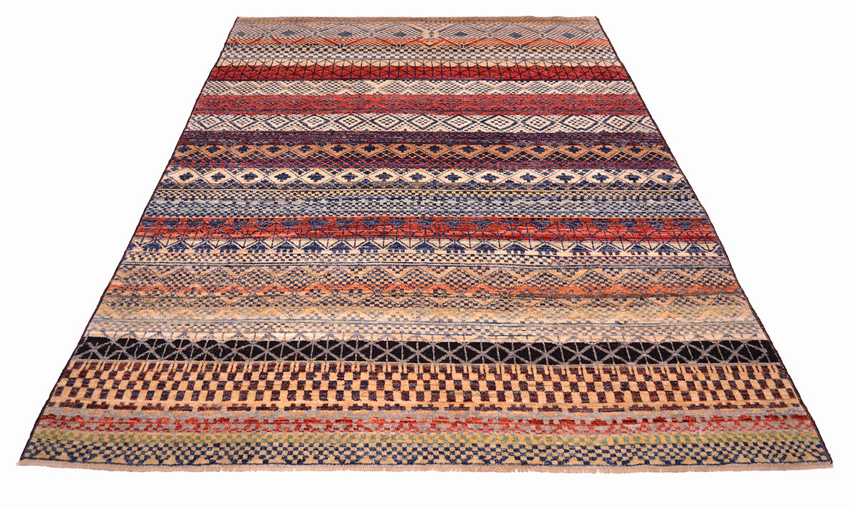 Overall view of modern geometric carpet with multitudes of geometrrc motifs with variety of colours made with natural vegetable dyes. Highly geometric carpet.