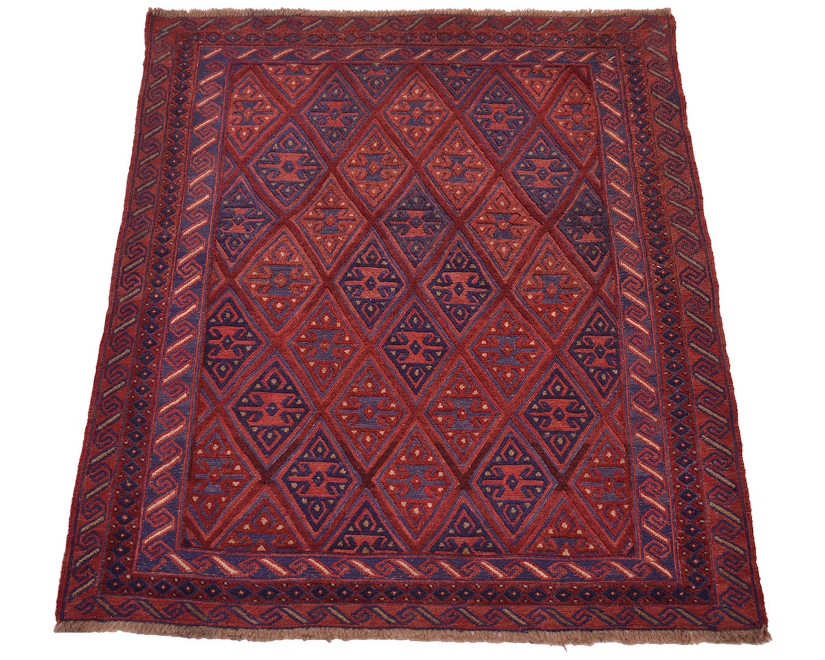 A square vintage Afghan-style Mushwani wool rug with a geometric diamond pattern in dark red, navy blue, and rust orange, featuring a thick patterned border and fringed edges.