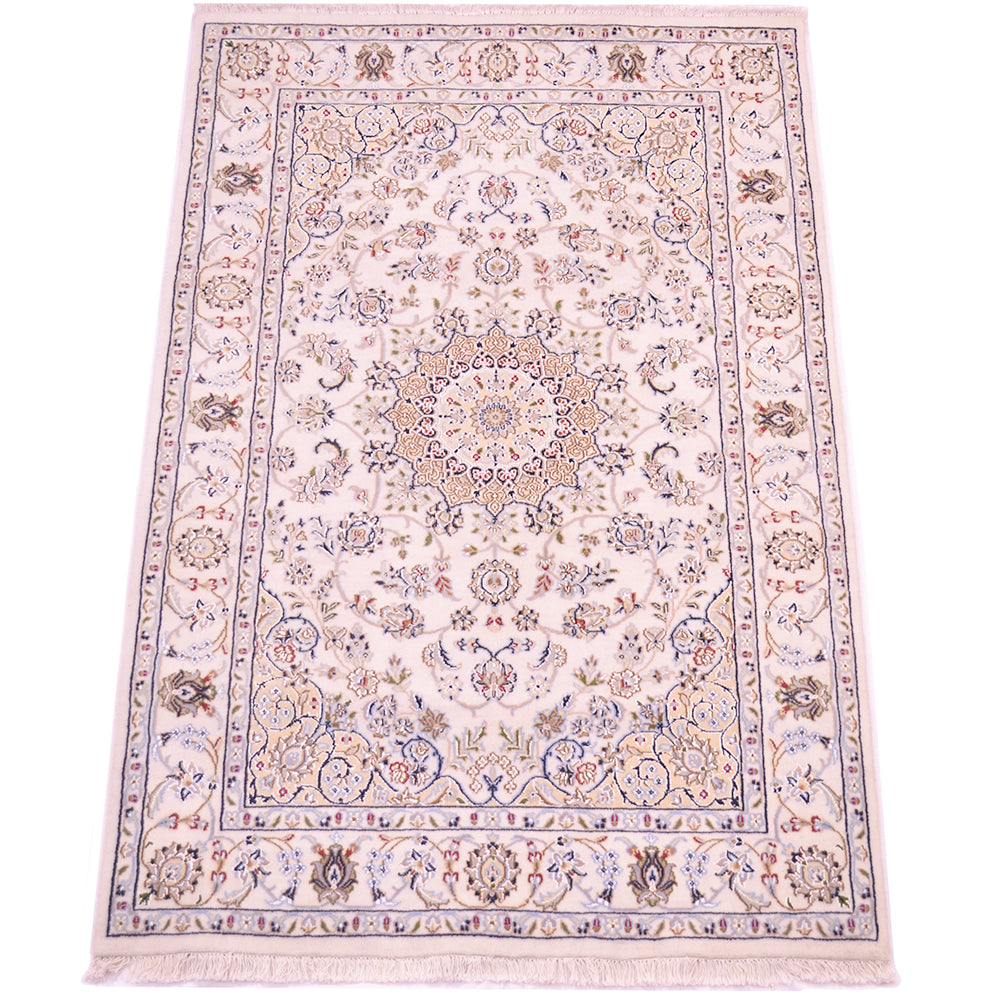 A 6x4 rectangular traditional Indo Persian Nain area rug with an intricate floral and medallion pattern, featuring a cream background with blue, beige, and muted red accents, finished with a fringed edge.