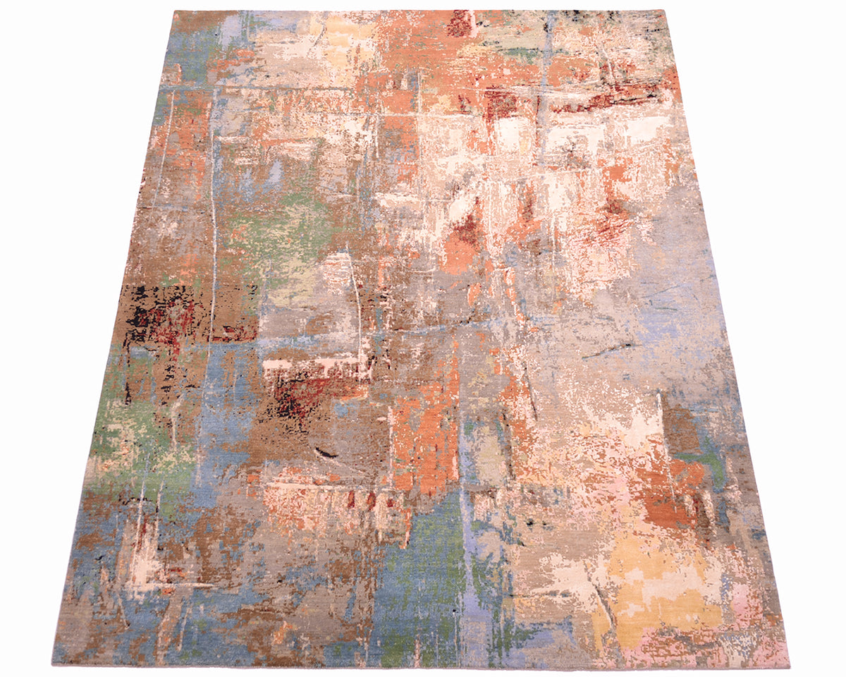 Overall view of Indain Abstract carpet wih eroded design and blue, green teal colours offset with warming bronzes, terracottas and creams silks.