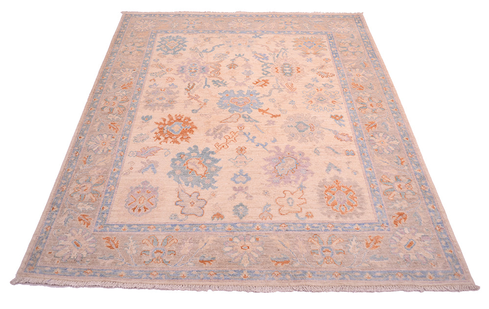 Ivory cream field of Afghan Oushak carpet in soft pastel colours.