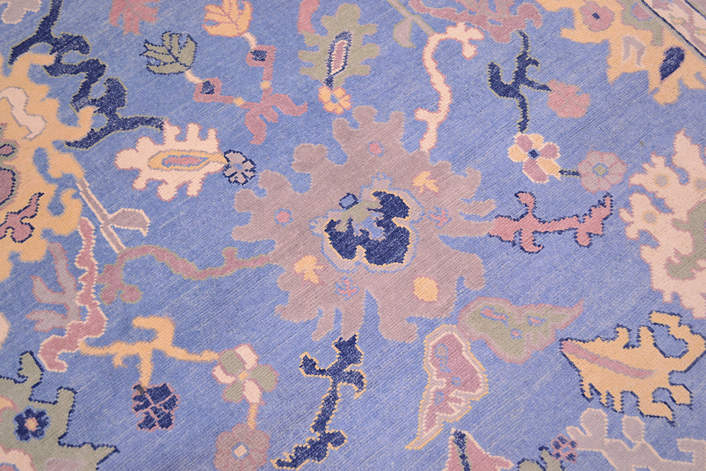 Detail of palmette and carnation flowers of handwoven carpet with blue field