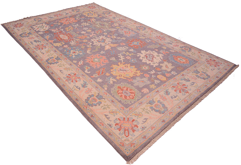Angle view of Oushak design carpet in pastels and grey tones