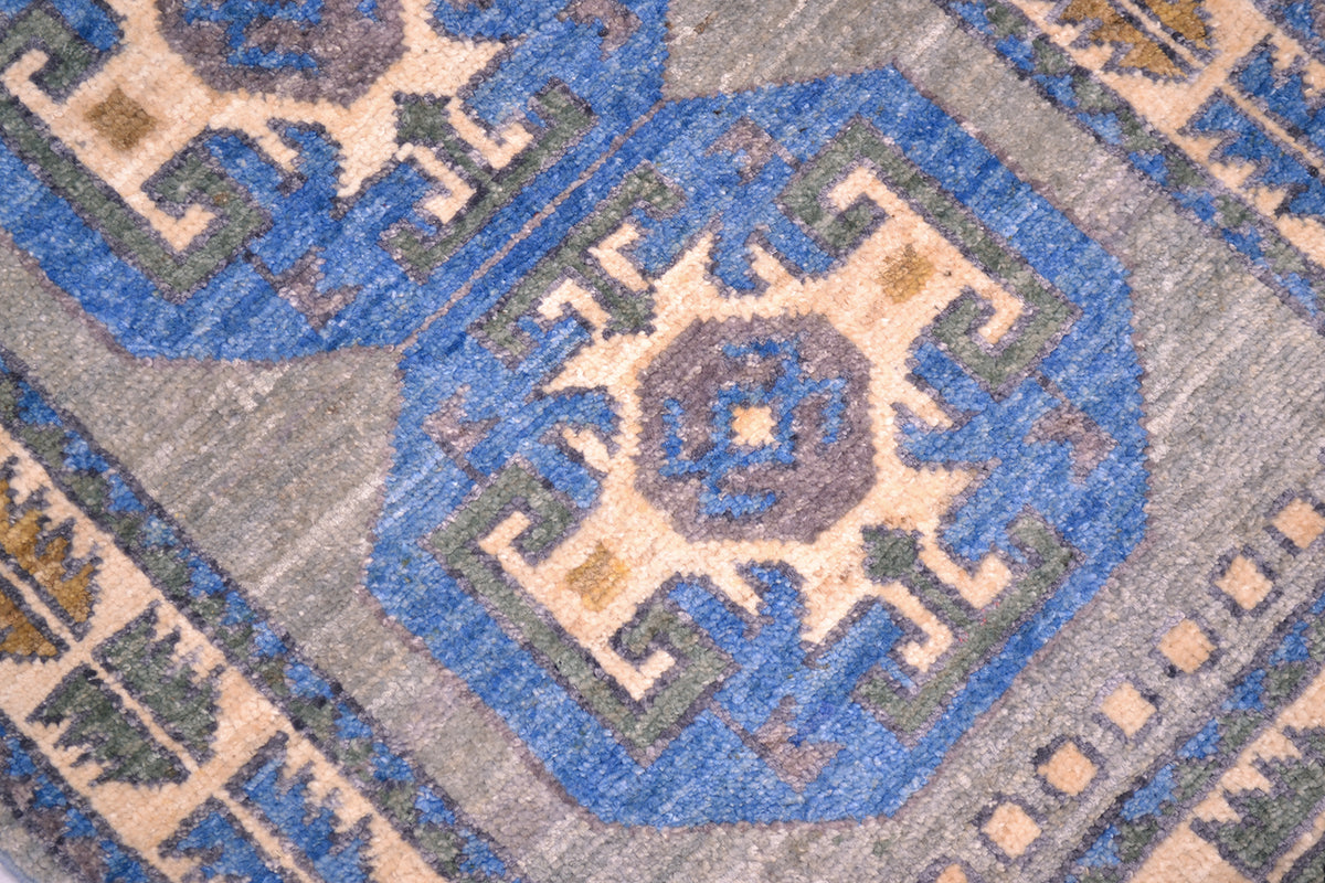 Detail of stunning blue, grey and cream octagonal motifs in afghan mat.