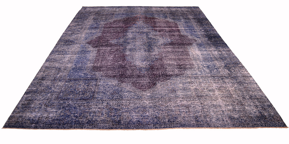 Overall view of vintage carpet in blue, indigo and aubergine on a white background. Fine knotting and vestiges of historical design and pattern. Rich colouration.