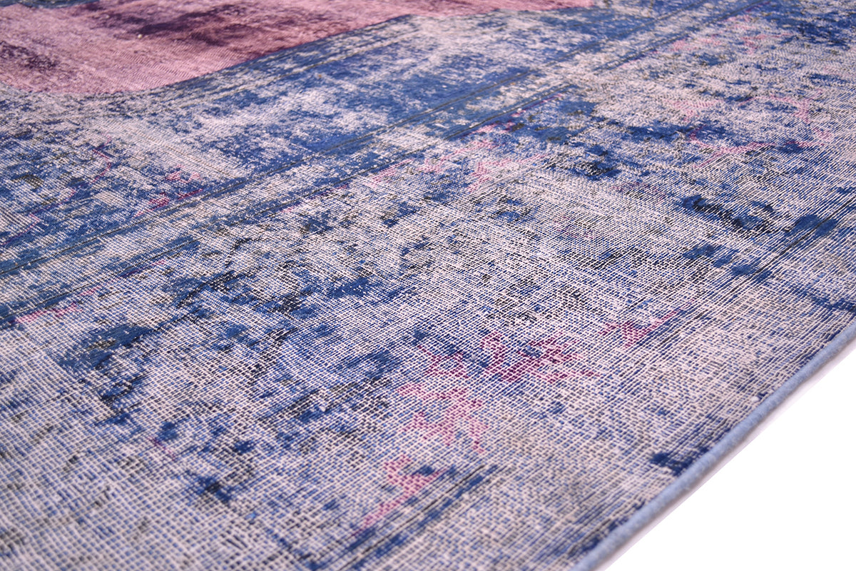 Edge of vintage overdyed carper created in Pakistan with cobalt like blue border with zero pile exposing cotton warp thread foundation. Historical border pattern still visible. Ultramarine,