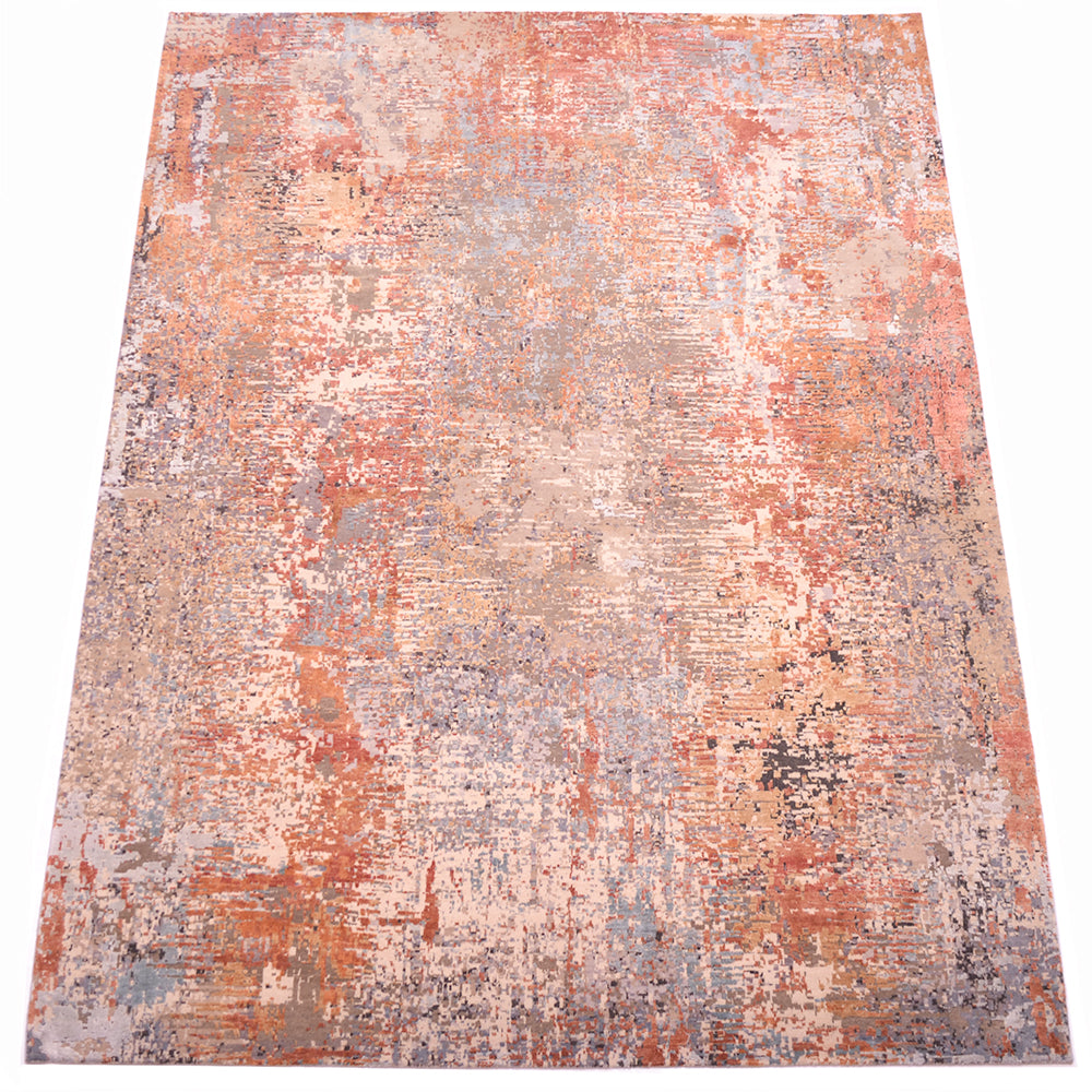 Overall view of modern expressionistic carpet with full wool pile and textured raised silk areas of ligth ble, light teal and terrattoa. Main base colours elements of charcoal, pewter grey, clays and stone tones.