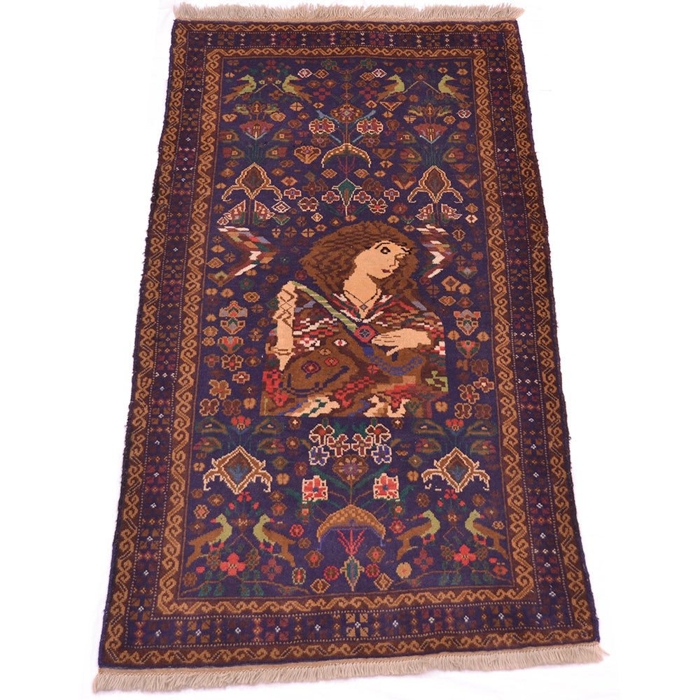 A rectangular hand-woven afghan rug with a dark navy blue field, featuring a central figure motif in warm tones and intricate geometric borders.