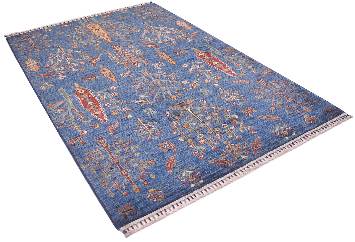 A rectangular blue Afghan pictorial area rug with an intricate traditional pattern in red, beige, and orange, featuring a fringed border on a white background.