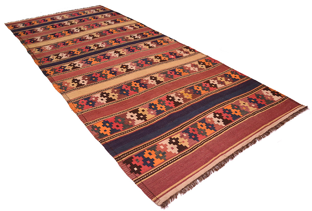 A long rectangular old Afghan kilim runner rug with a traditional geometric pattern in shades of terracotta, navy blue, orange, beige, and black, shown on a plain white background.