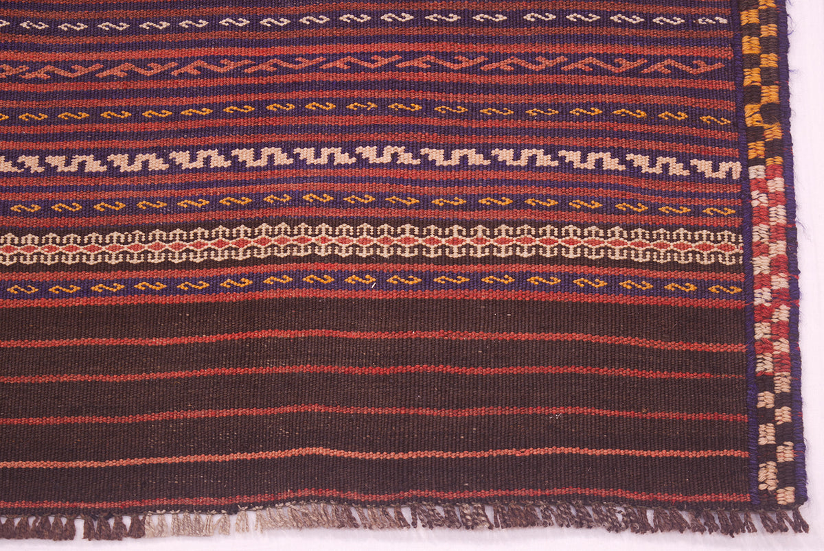 Vintage Kilim rug border with fringe and multicolor geometric bands in dark red
