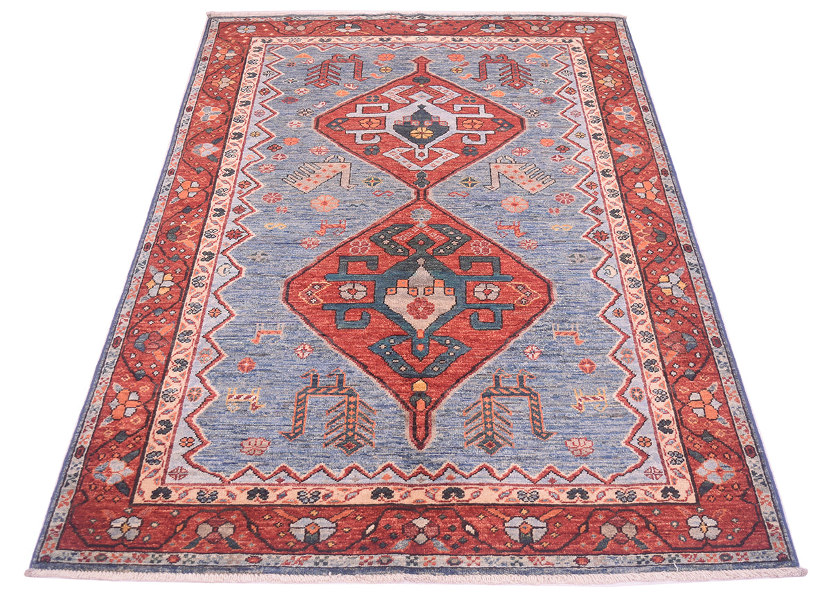 A traditional hand-knotted Afghan wool Qashqai design rug with a central blue field, red diamond medallions, and a patterned border, shown flat against a white background.