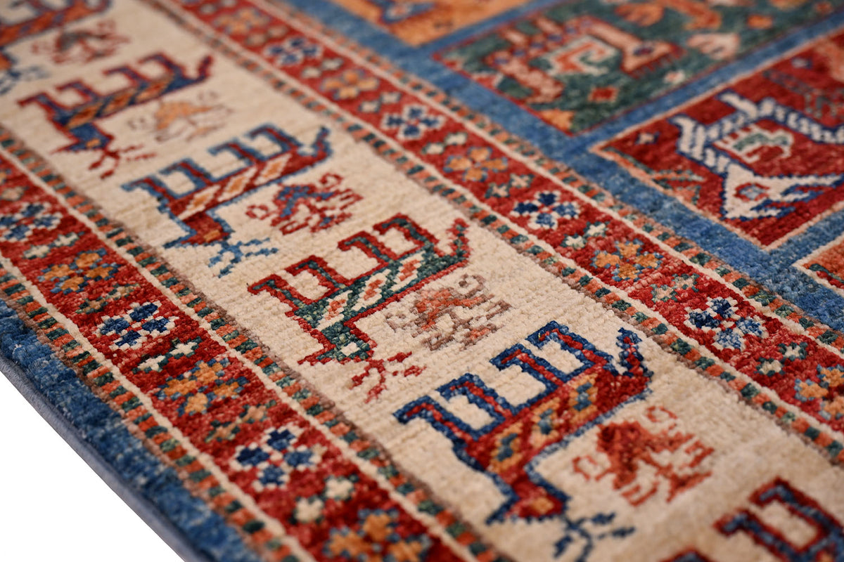 Small rug corner detail with cream field and red-blue geometric patterning