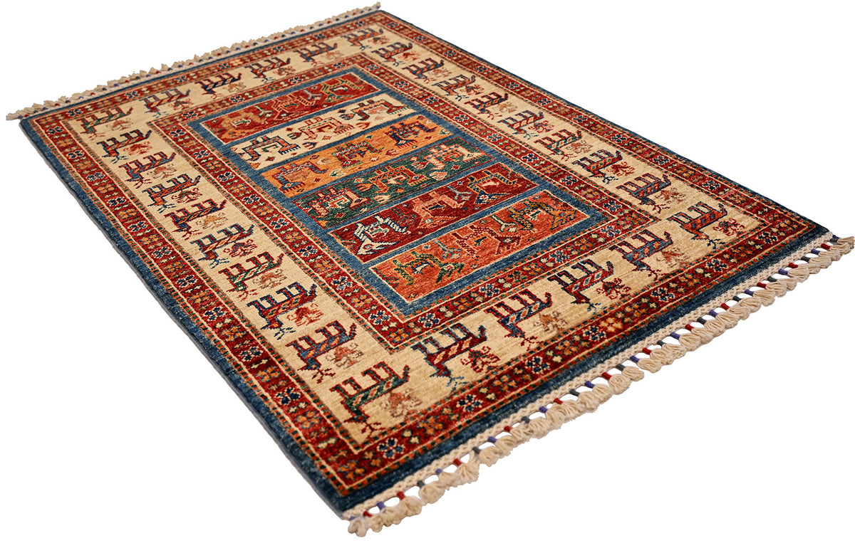 Folded small rug showing red, blue, and cream central medallion design