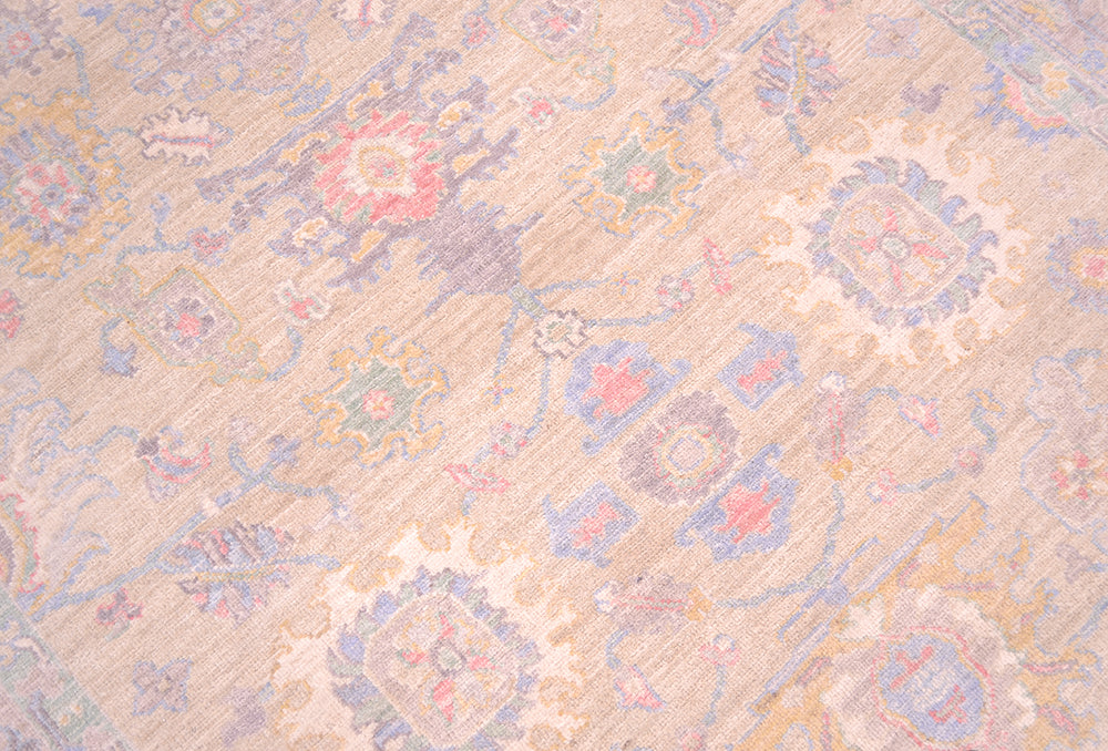 Detailed view of main field of Afghan Rug with Serapi design and all over floral motifs. Cream/ pale gold yellow field colour with accents of pink, blue, mauve grey and creamy white.