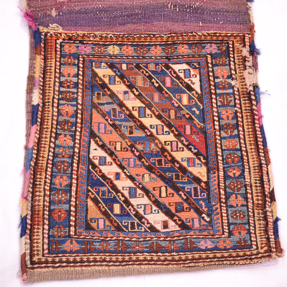 Antique khorjin rug front view with diagonal stripe motif; blue, orange, rust, and fringe