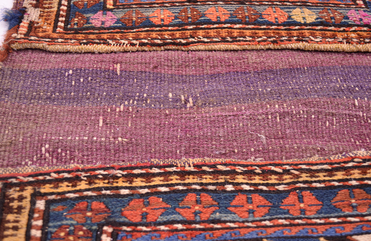 Antique khorjin textile in maroon and purple, with geometric border motifs