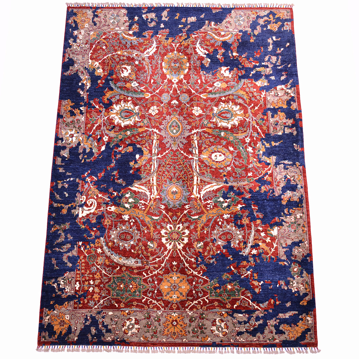 An ornate rectangular Handmade Modern Sickle-Leaf area rug with a traditional floral pattern, featuring a deep navy blue field, a large central red medallion, and cream, orange, and green accents, finished with fringed edges.