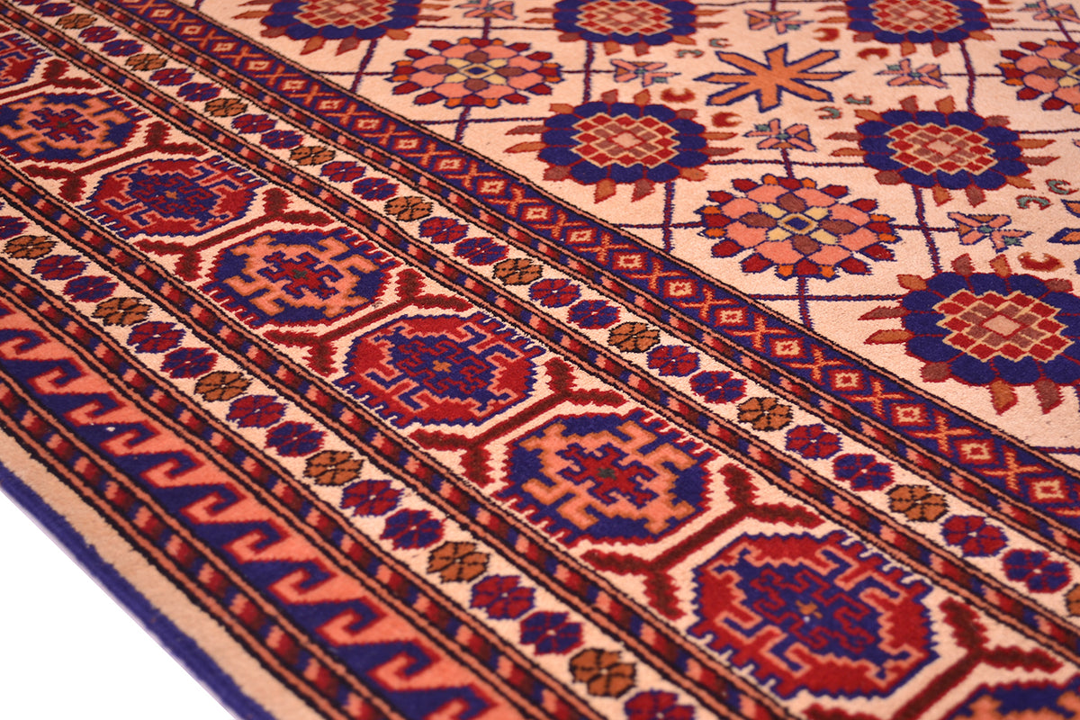Close-up of Kabul silk and wool rug border with red, blue, and geometric zigzag bands