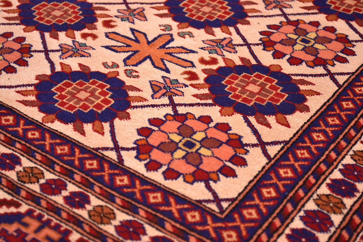 Close-up of Kabul silk and wool rug with cream background and multicolor diamond medallions