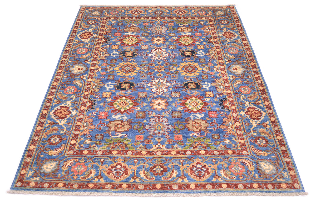 View of Handwoven rug with fmaous Sultanabad Persian design with all over field pattern with flowerheads and palmettes wirh elelgant border with rosettes, vines and leaves. Warm gold yellow warm the blue field.