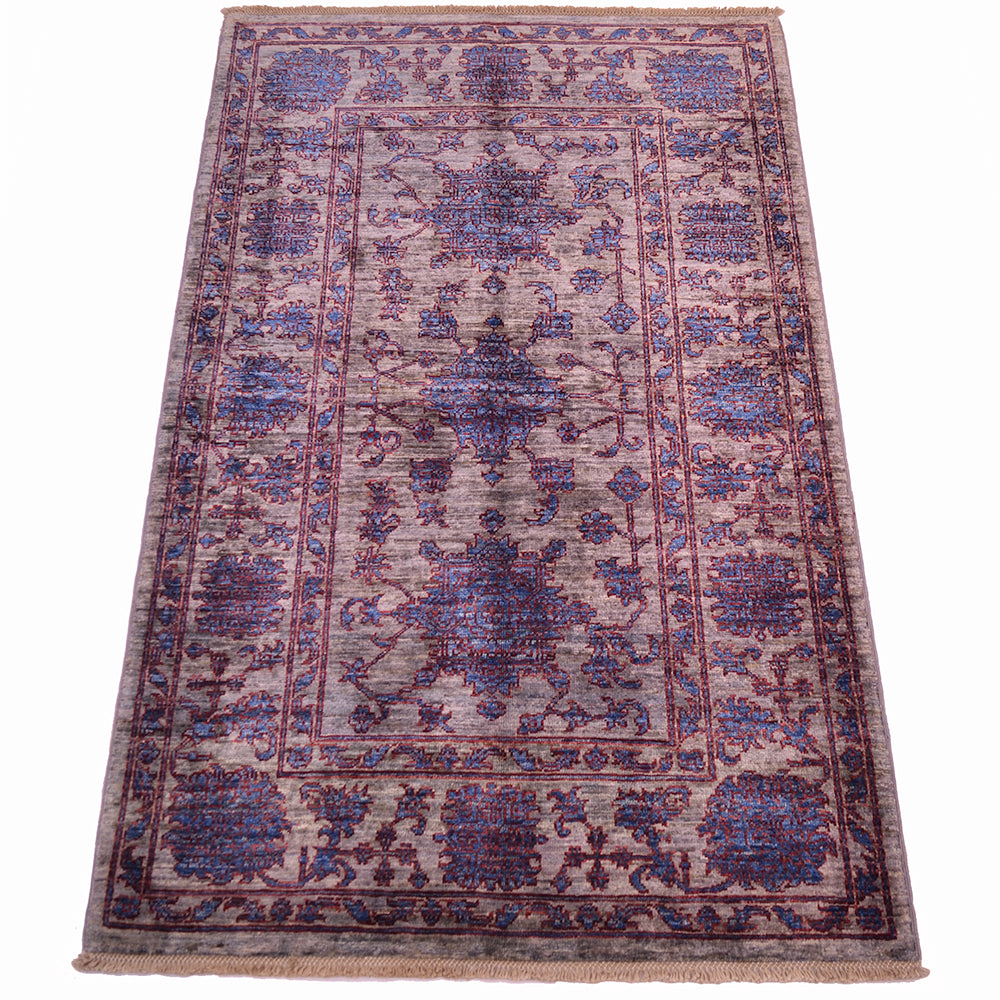 All over floral design with gernouos flowerheads in blue with a rich red outlings on a contrsting daerk silver ground with pure wool pile.