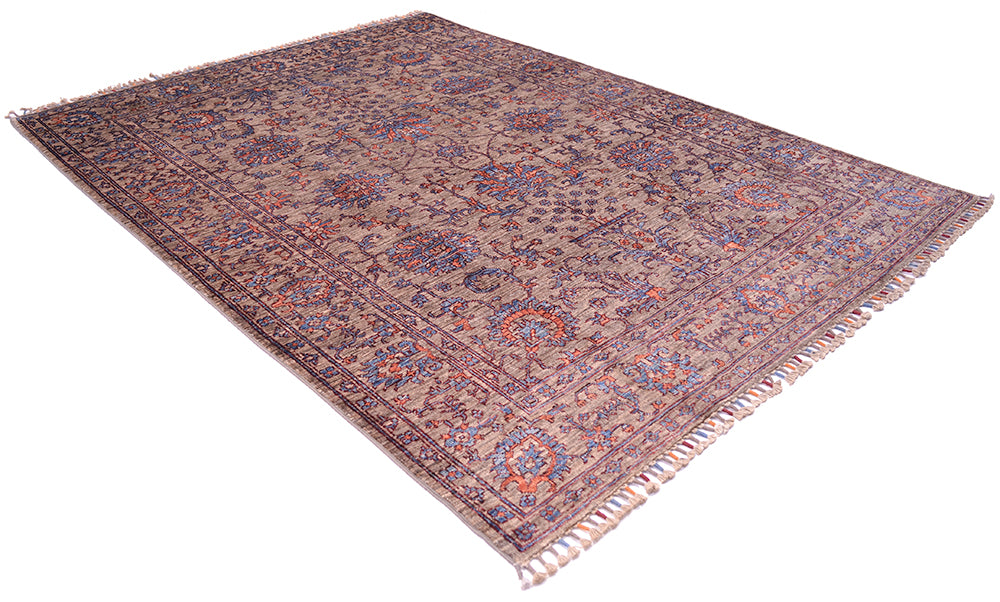 Angled view of handknotted Afghan Sultani rug with neutral grey-brown ground and hints of blue and orange terracotta.Vase and floral motifs also apparent with traditional all over floral design.
