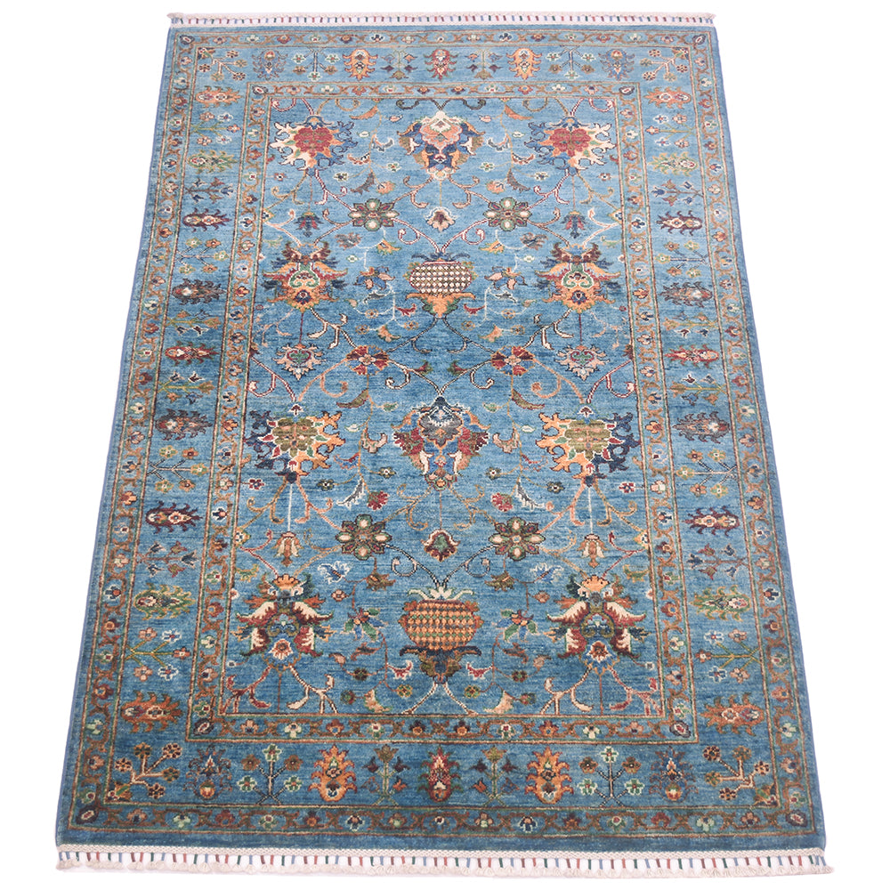 All over floral design of handmade blue sultani rug with floral design of antiquity with modern cheerful colours. Multiple floral motifs throughout filed and border.