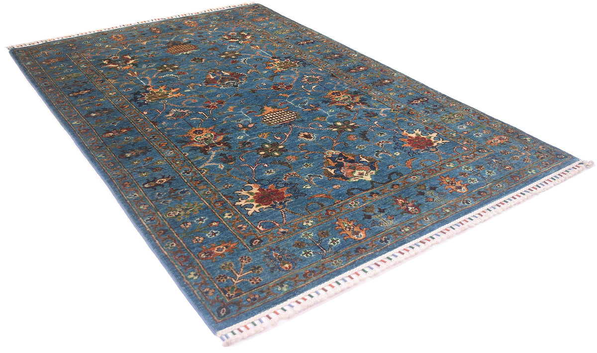 Angled view with white background of Afghan sultani rug hnadknotted with oure handsoun wool. Interpretaions fo a classic persian floral carpet.