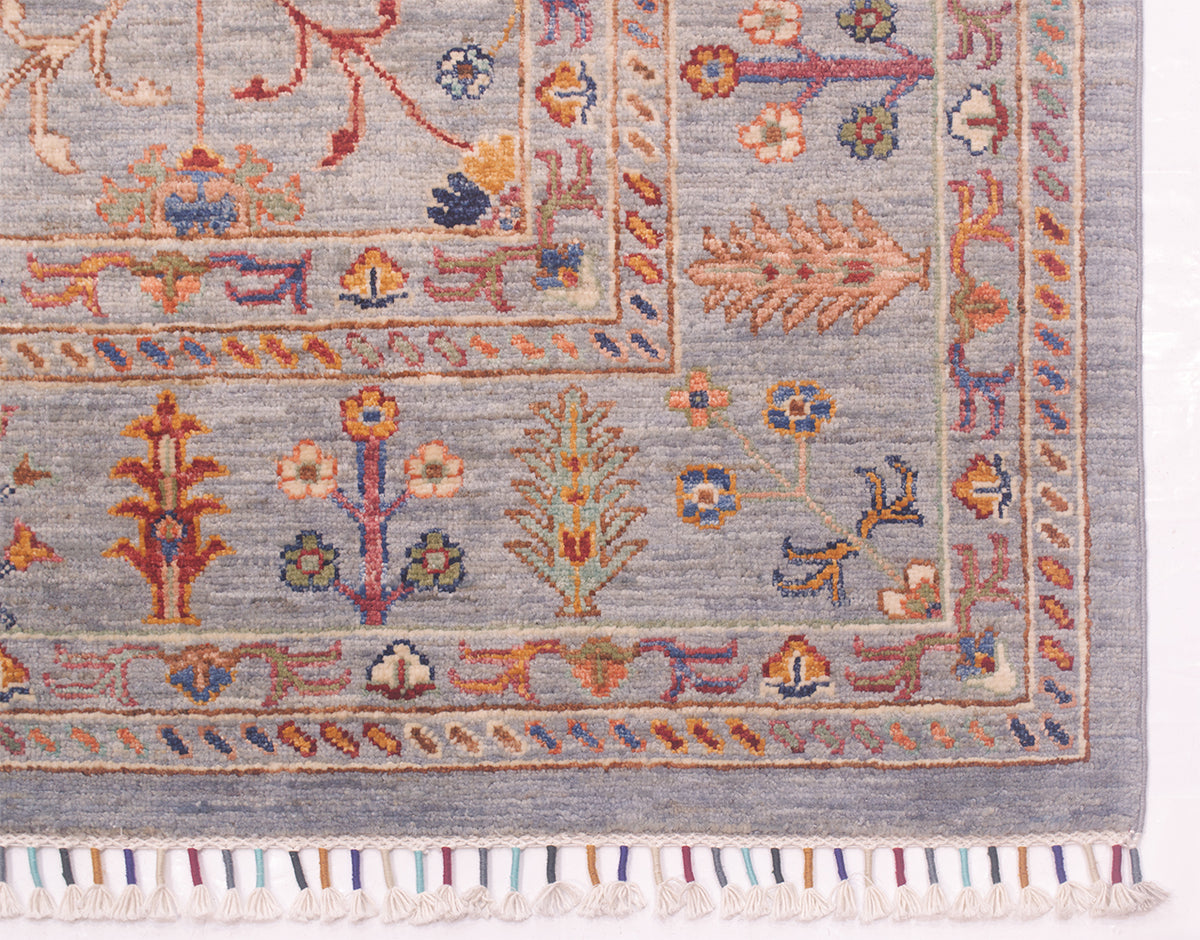 Corner detail of Sultani carpet with Floral Persian design features of flowing florals and interconnecting vine network of Afghan Carpet.