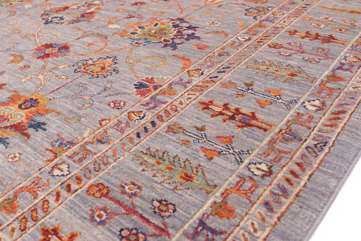 Border of handwoven carpet with stylized plants and tree motifs with multitude of contrasting colours. Handwoven pure wool pile.