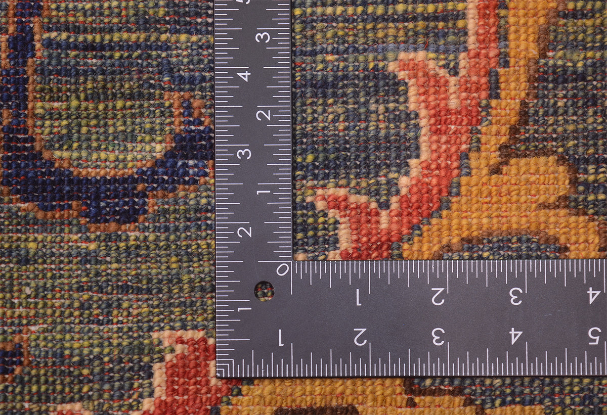 Close-up of hand-knotted back of Afghan Suzani design handmade carpet with a dark grey L-shaped ruler showing measurements in centimetres and inches to indicate scale.