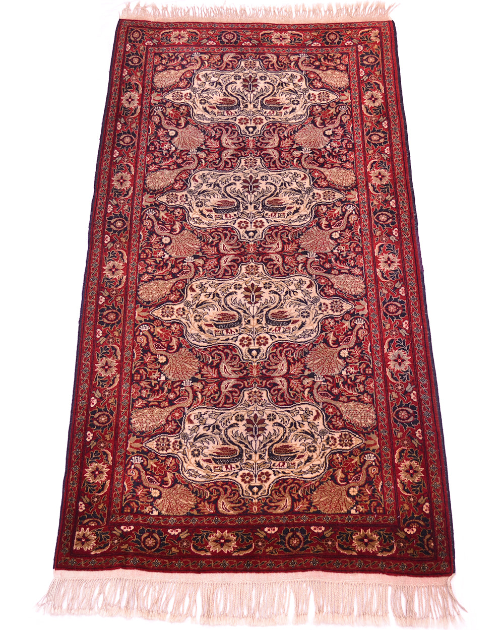 Old Belouch-Tavusi rug angled view with ornate red and cream motifs, light pink fringe.