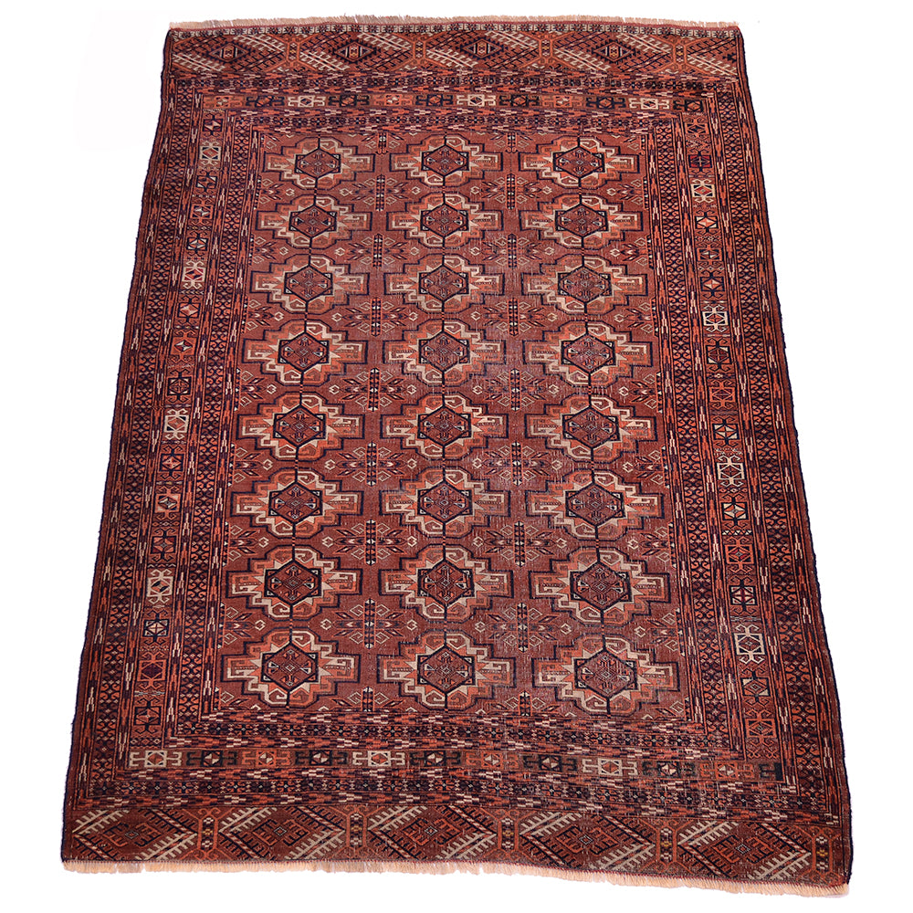 A 7x5 rectangular traditional fine antique Tekke rug with a geometric pattern in shades of brown, orange, black and beige, shown flat against a white background.