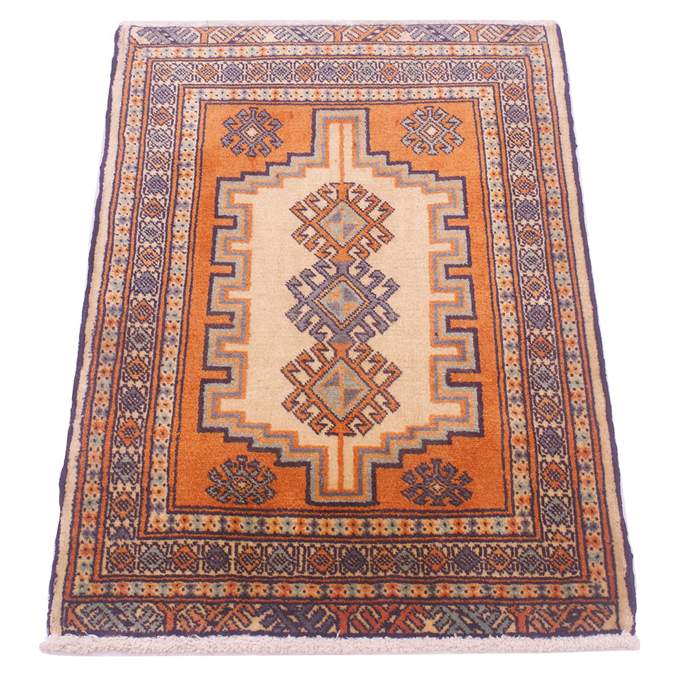 A rectangular hand-knotted area rug mat with a traditional geometric pattern, featuring a central cream field, an orange-brown field, and a dark navy blue edge