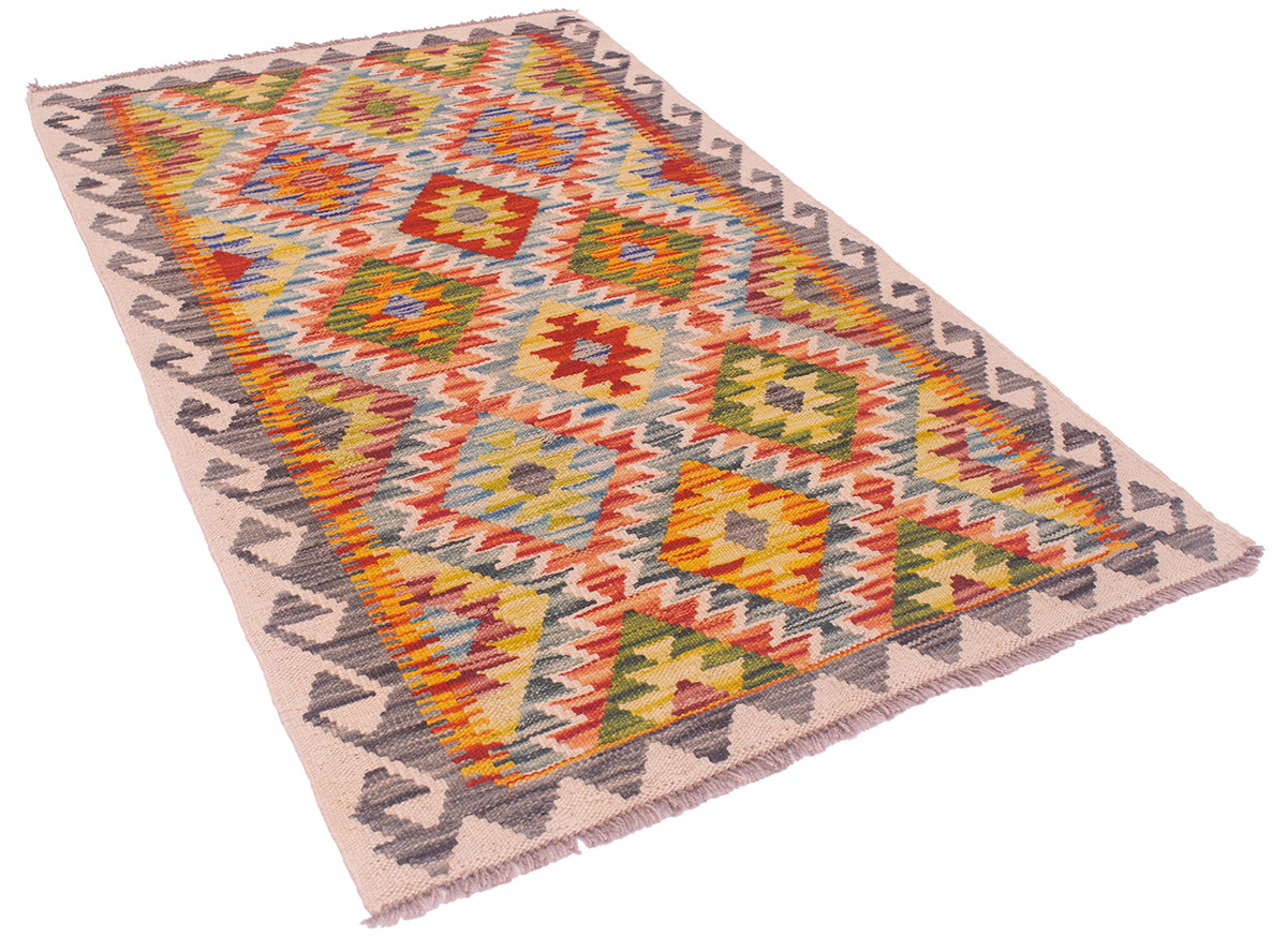 A rectangular Multicolour Afghan kilim rug with a geometric diamond and zigzag pattern in multiple colours, including orange, yellow, green, blue, red, and grey, on a cream background with fringe.