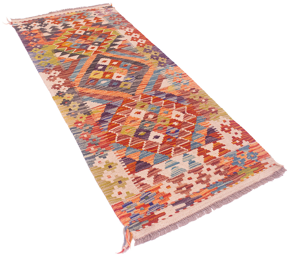 A Small Afghan Kilim Strip / runner rug with a vibrant geometric pattern in orange, red, blue, green, and beige, featuring fringed ends, shown on a plain white background.