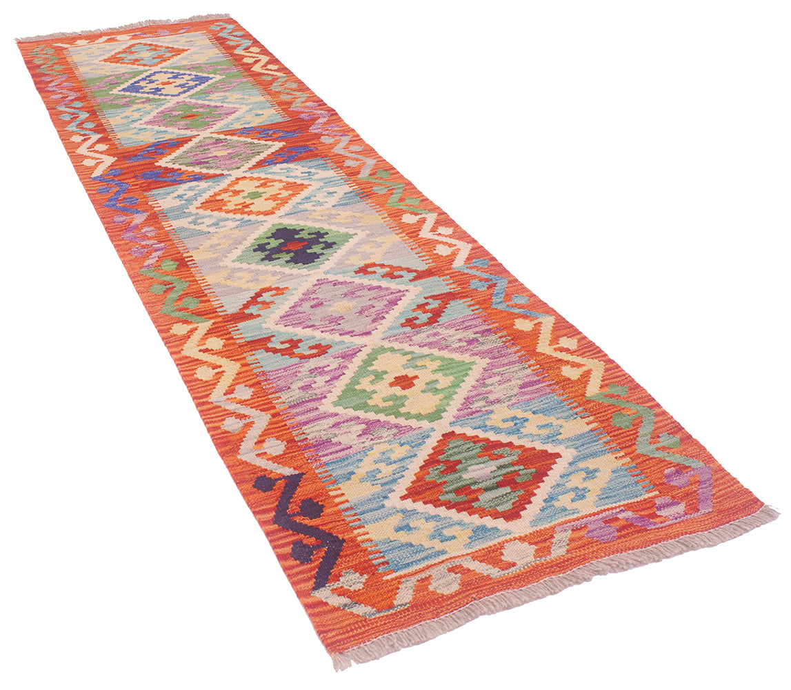 A 2m long kilim runner rug with a vibrant multicolour geometric pattern, featuring orange borders and diamond motifs in shades of blue, green, purple, and red on a white background.