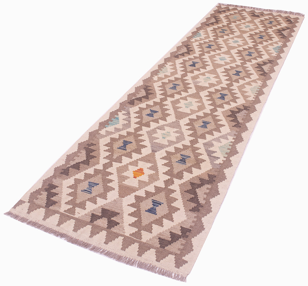 A 9'6 long rectangular woven Afghan Natural Dye Kilim Runner with a geometric tribal pattern in beige, brown, and muted blue, featuring a small orange accent and fringed ends, shown on a plain white background.